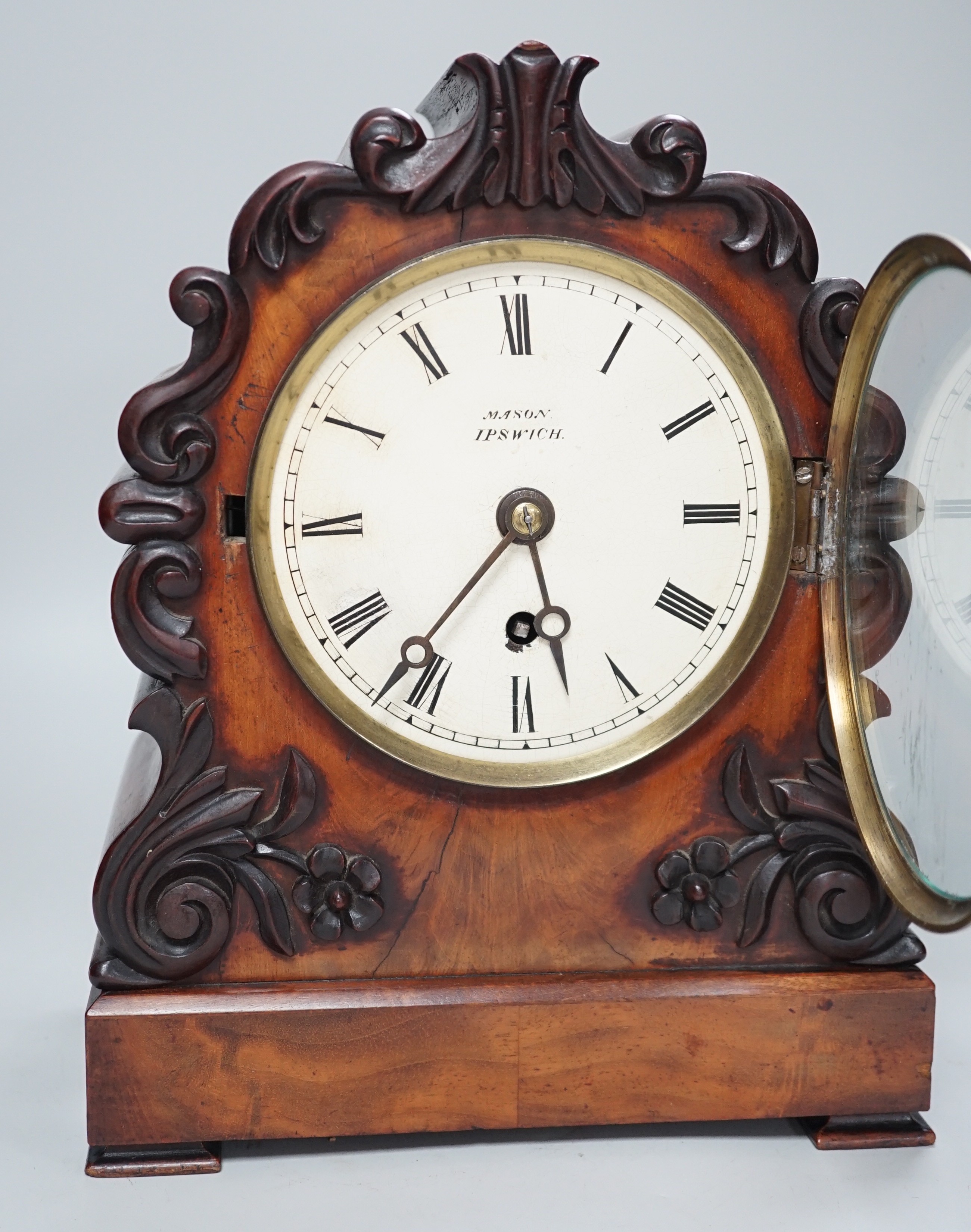 Mason, Ipswich. A 19th century mahogany cased mantel clock with scrolling moulded decoration - 31cm tall